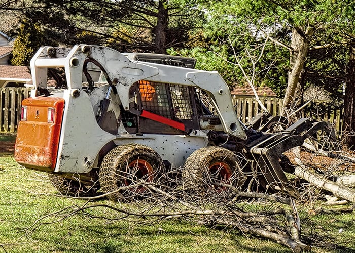 Bobcat Wheel Skid Steer Loader with Root Grapple Attachment